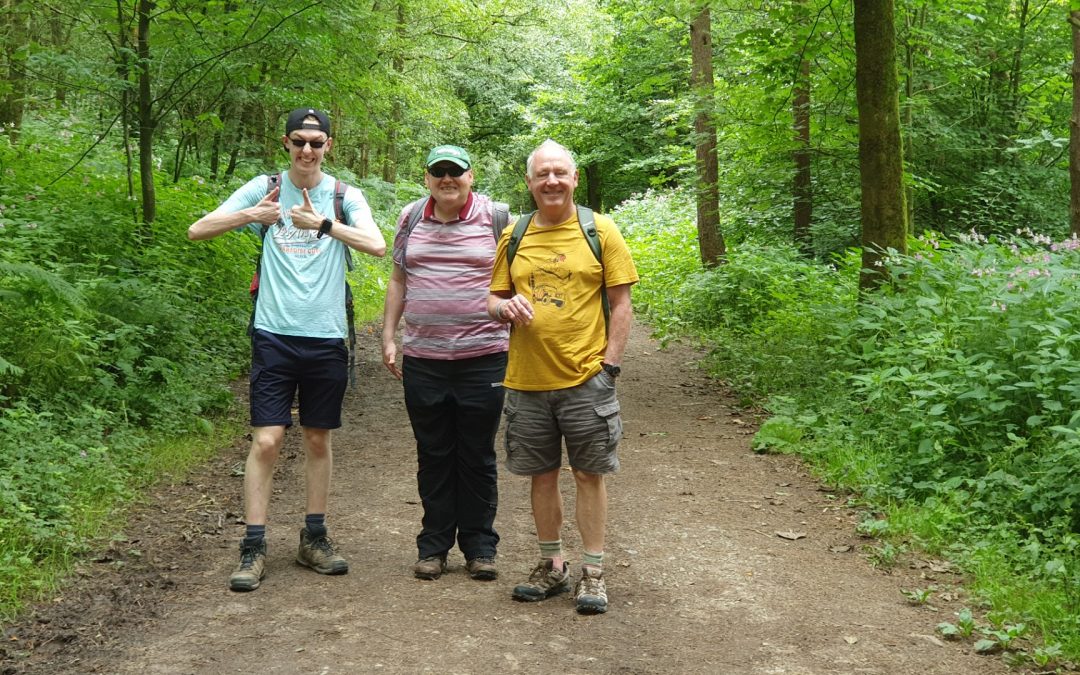 three men on a woodland walk.