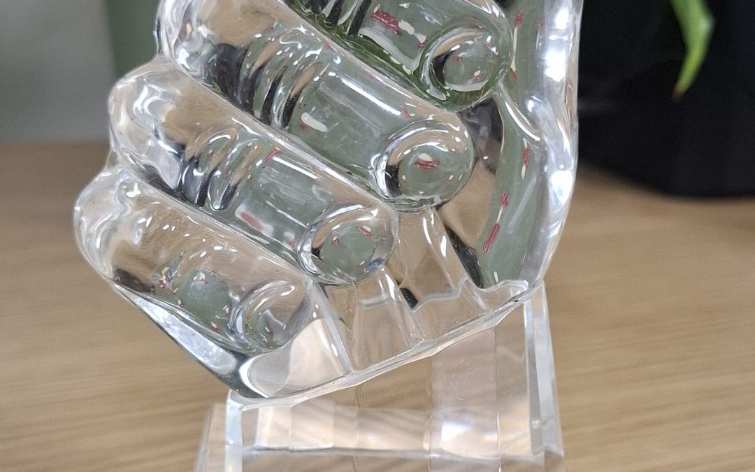 A glass ornament in the shape of a giant thumbs up, engraved with the words "Winner of the Open Country Good Access Scheme"